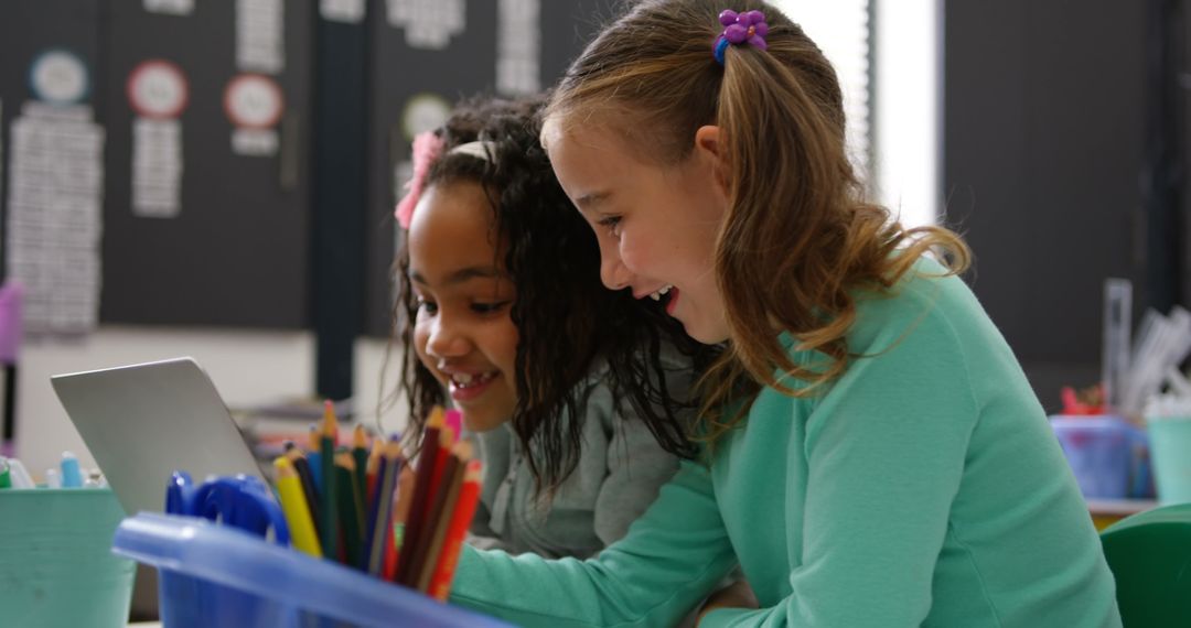 Cheerful Schoolgirls Learning and Laughing in Classroom Setting