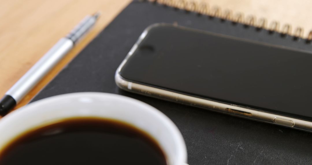 Workspace with Coffee Cup, Smartphone, and Notepad on Desk - Free Images, Stock Photos and Pictures on Pikwizard.com