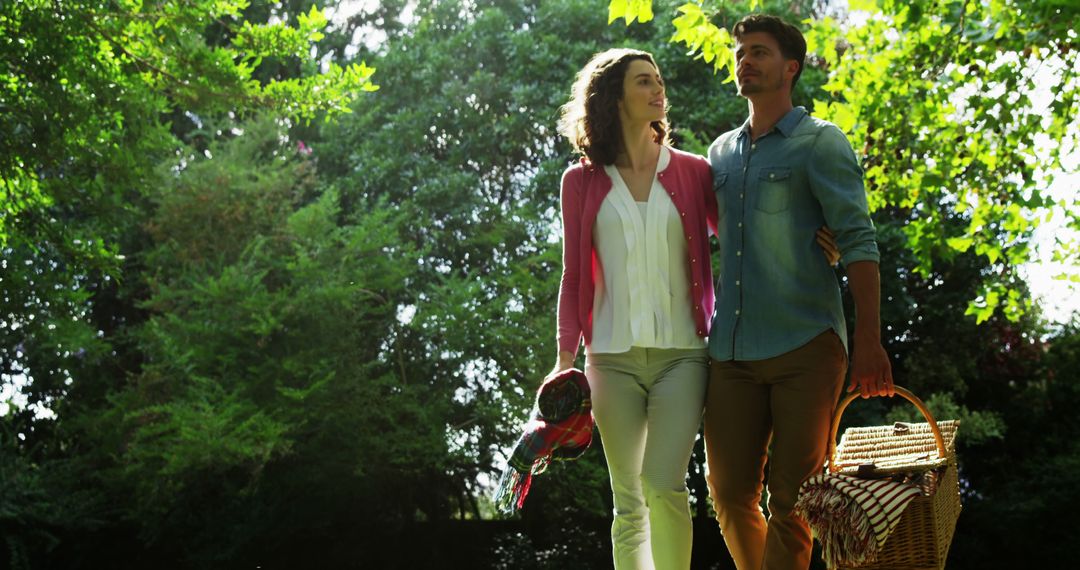 A young Caucasian couple enjoys a romantic walk in a lush park, with copy space - Free Images, Stock Photos and Pictures on Pikwizard.com