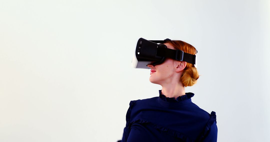 Woman Experiencing Virtual Reality with VR Headset in Minimalist Setting - Free Images, Stock Photos and Pictures on Pikwizard.com