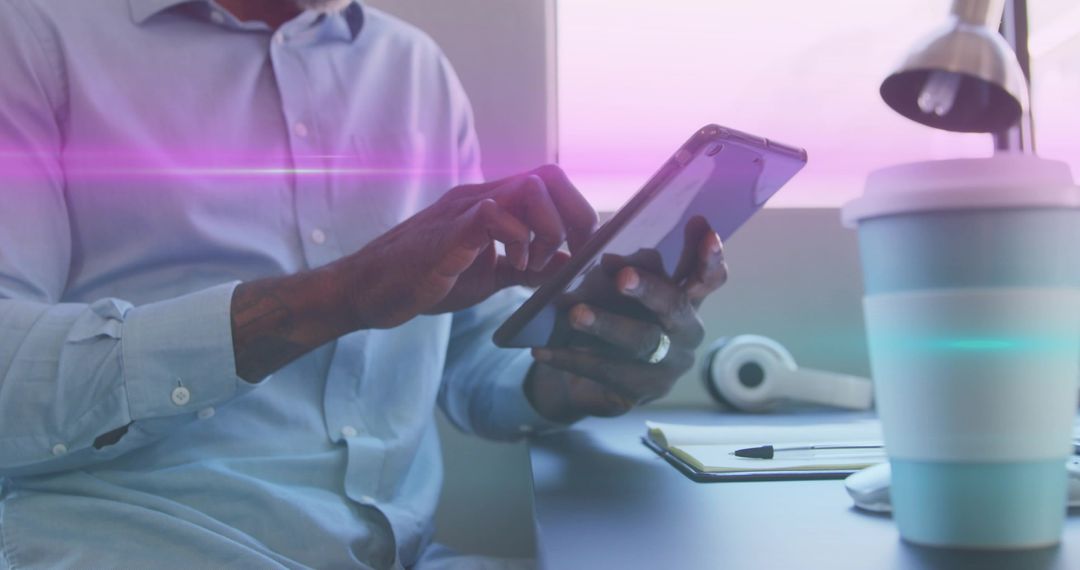 Focused Professional Engaging with Tablet in Modern Workspace