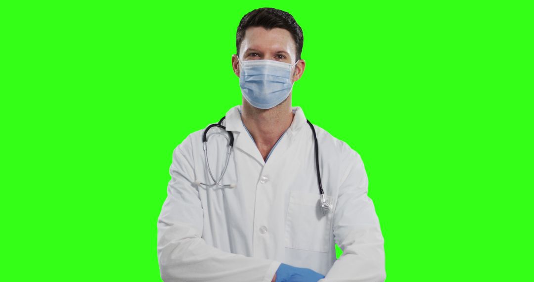 Confident Doctor Wearing a Mask Standing Green Background - Free Images, Stock Photos and Pictures on Pikwizard.com