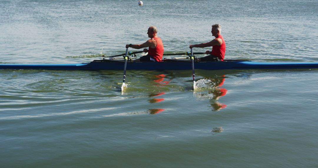 Two senior caucasian men rowing boat on a river - Free Images, Stock Photos and Pictures on Pikwizard.com