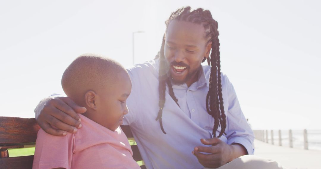 African American Father Comforting Sad Son on Park Bench - Free Images, Stock Photos and Pictures on Pikwizard.com