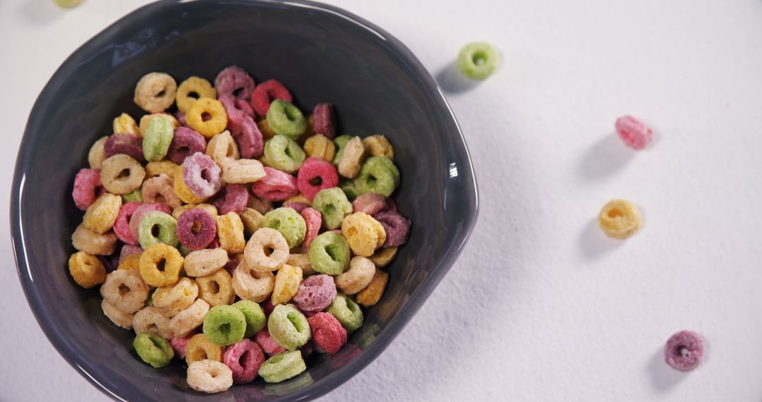 Colorful Fruit Loops in Black Bowl on White Background - Free Images, Stock Photos and Pictures on Pikwizard.com