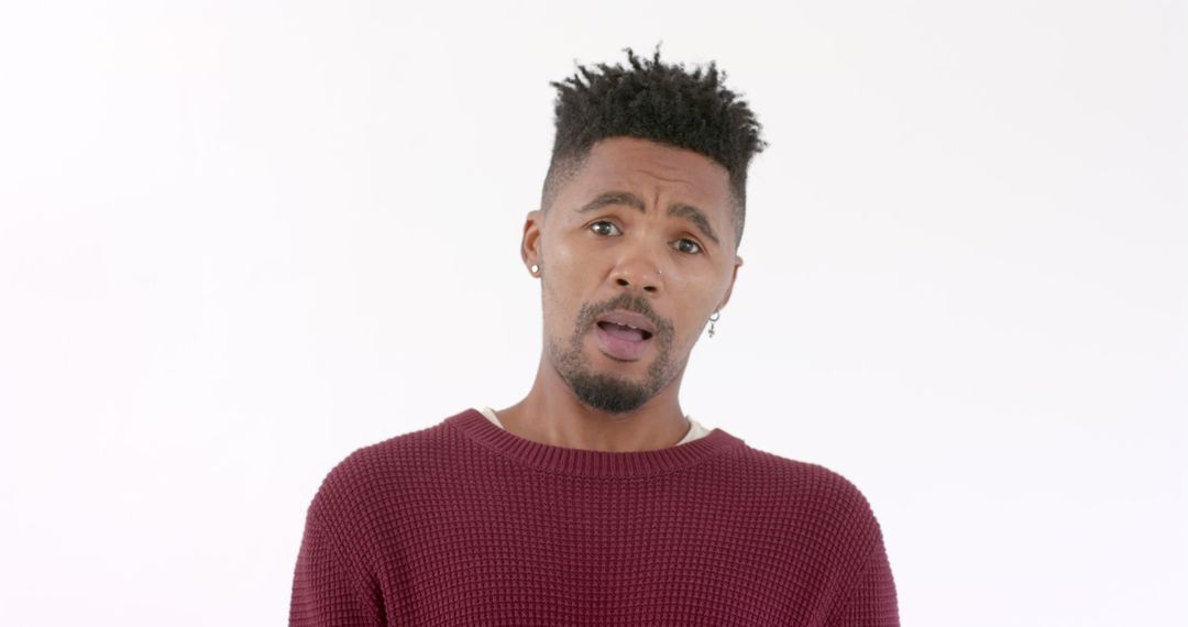 Confident Man in Red Sweater Showing Curiosity