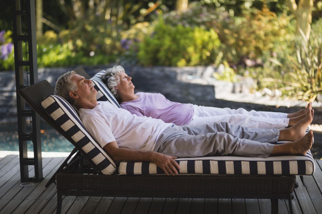 Full length of senior couple resting together on lounge chairs - Free Images, Stock Photos and Pictures on Pikwizard.com
