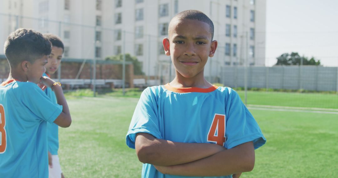 Confident Young Soccer Player on Field With Teammates - Free Images, Stock Photos and Pictures on Pikwizard.com