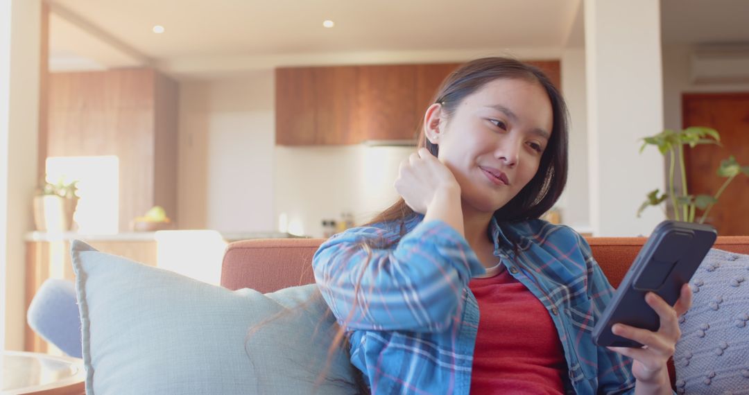 Woman Relaxing at Home Checking Smartphone