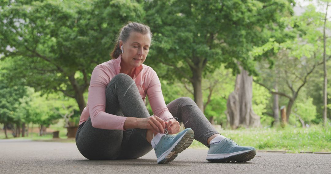 Senior Woman Tying Sneaker Laces in Park During Exercise - Free Images, Stock Photos and Pictures on Pikwizard.com