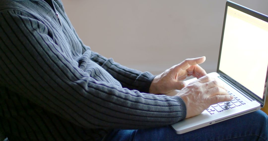 Man Typing on Laptop in Cozy Home Environment - Free Images, Stock Photos and Pictures on Pikwizard.com