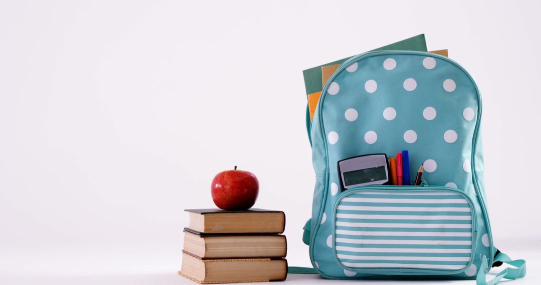 Polka-Dotted Backpack with School Supplies and Books Symbolizing Education