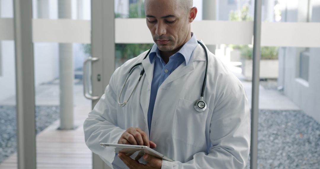 Doctor Using Digital Tablet with Stethoscope in Modern Clinic - Free Images, Stock Photos and Pictures on Pikwizard.com