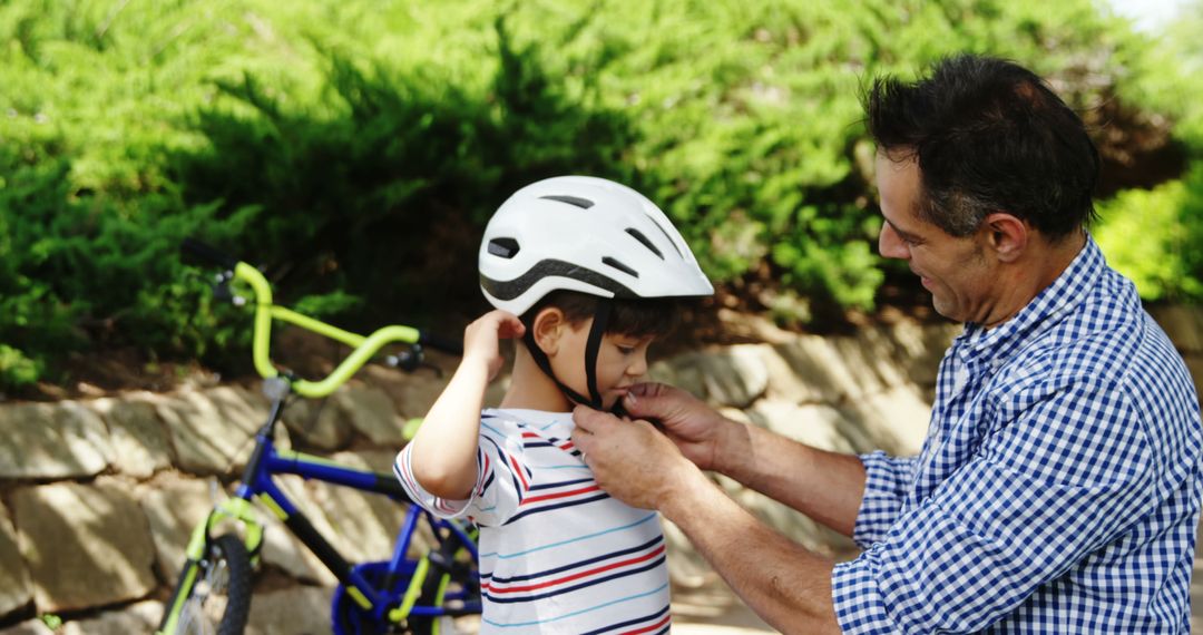 Caring Father Helping Child Wear Helmet for Bike Ride - Free Images, Stock Photos and Pictures on Pikwizard.com