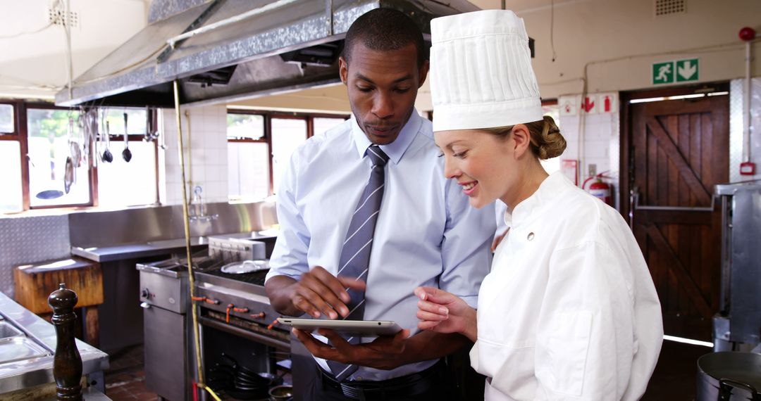 Restaurant Manager Discussing Menu with Chef - Free Images, Stock Photos and Pictures on Pikwizard.com