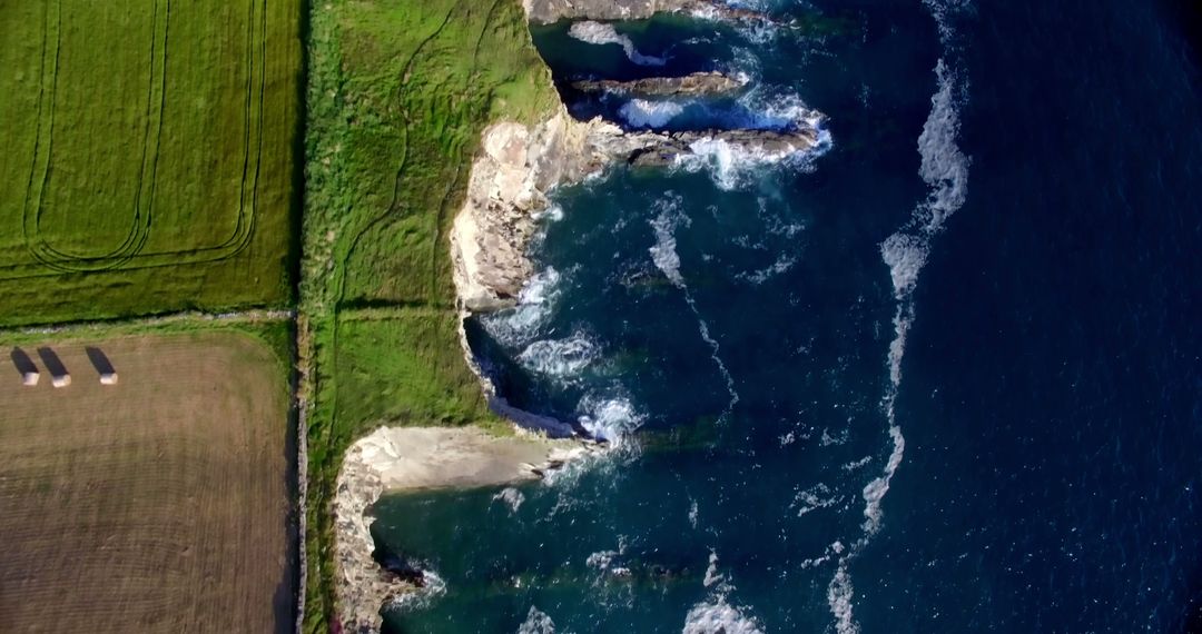 Aerial View of Coastal Cliff and Ocean Waves Hitting Rocky Shoreline - Free Images, Stock Photos and Pictures on Pikwizard.com