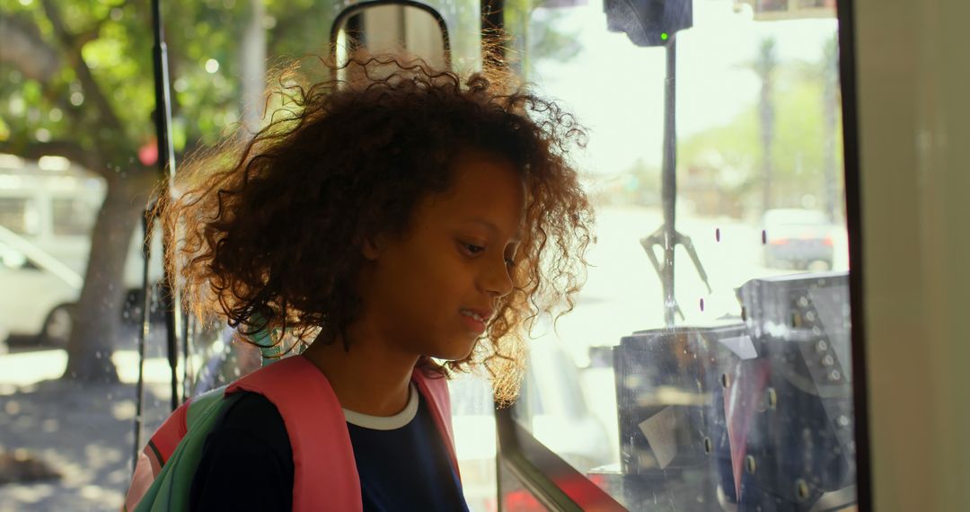 Curly-Haired Girl with Backpack Boarding Bus on Sunny Day - Free Images, Stock Photos and Pictures on Pikwizard.com