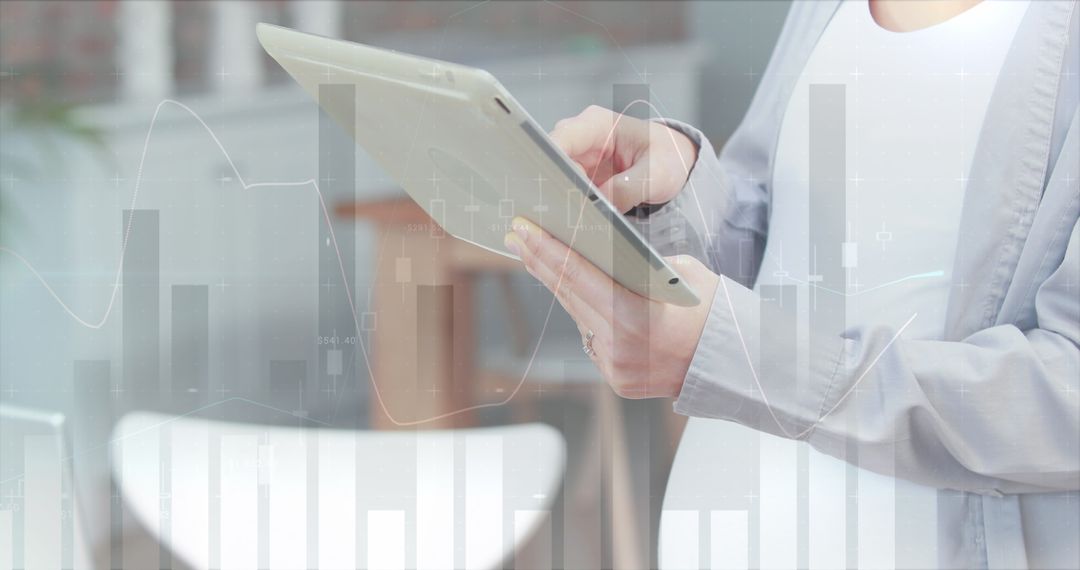 Businesswoman Using Tablet with Overlay of Financial Graphs