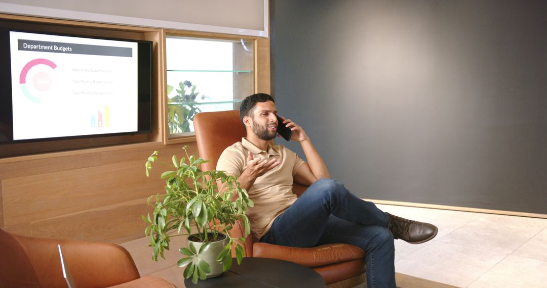 Casual Businessman Having Phone Call in Modern Office