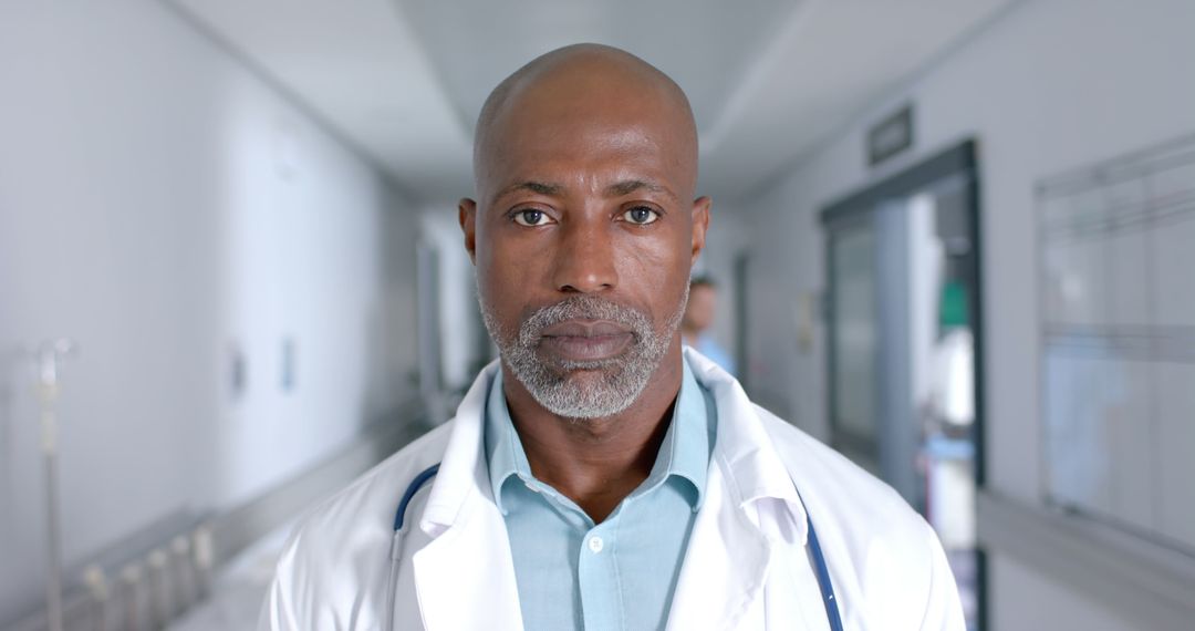 Confident Black Male Doctor Standing in Hospital Hallway - Free Images, Stock Photos and Pictures on Pikwizard.com