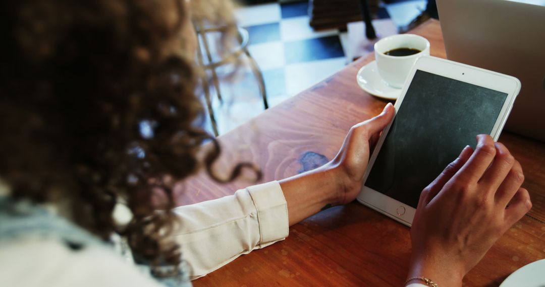 Woman Using Digital Tablet in Cozy Coffee Shop - Free Images, Stock Photos and Pictures on Pikwizard.com