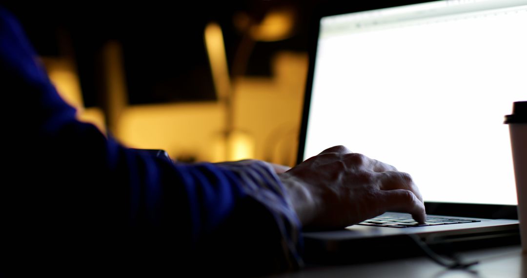 Person Working on Laptop in Dark Room with Coffee Cup - Free Images, Stock Photos and Pictures on Pikwizard.com