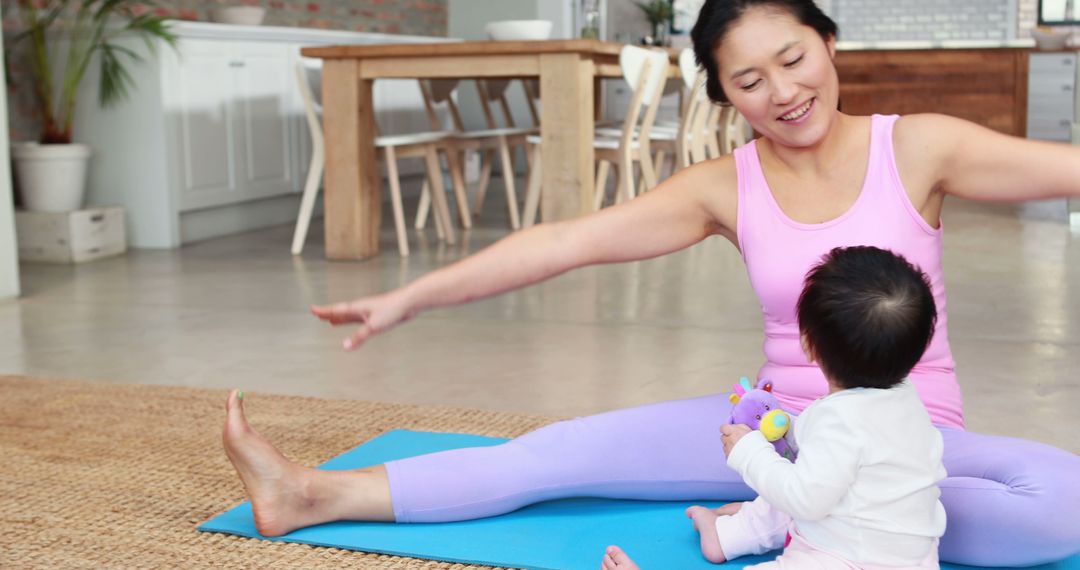 Mother Doing Yoga at Home with Baby in Bright Minimalist Kitchen - Free Images, Stock Photos and Pictures on Pikwizard.com