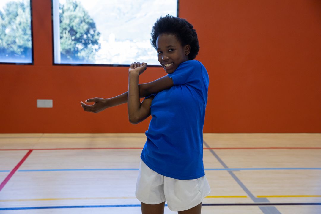 Young Athlete Stretching in Gym Ready for Training