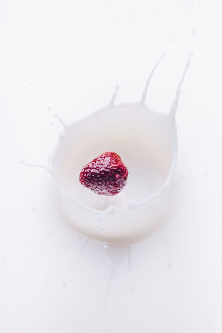 Fresh Strawberry Splashing into Milk on White Background - Free Images, Stock Photos and Pictures on Pikwizard.com