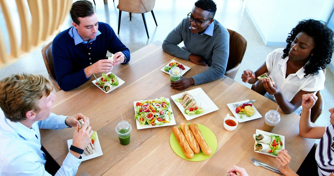 Diverse colleagues enjoying a healthy lunch together - Free Images, Stock Photos and Pictures on Pikwizard.com