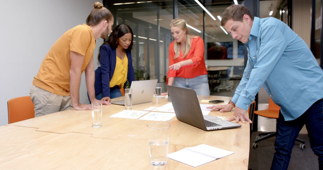 Team Collaborating in Modern Office Encouraging Creative Solutions