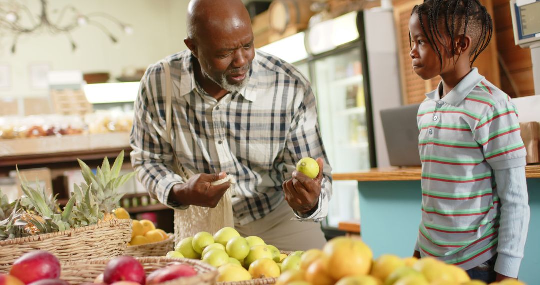 Grandfather and Grandson Choosing Fruits in Grocery Store - Free Images, Stock Photos and Pictures on Pikwizard.com