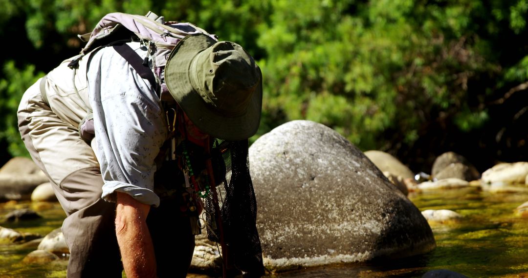Fly Fisherman Exploring Shallow River Waters on Sunny Day