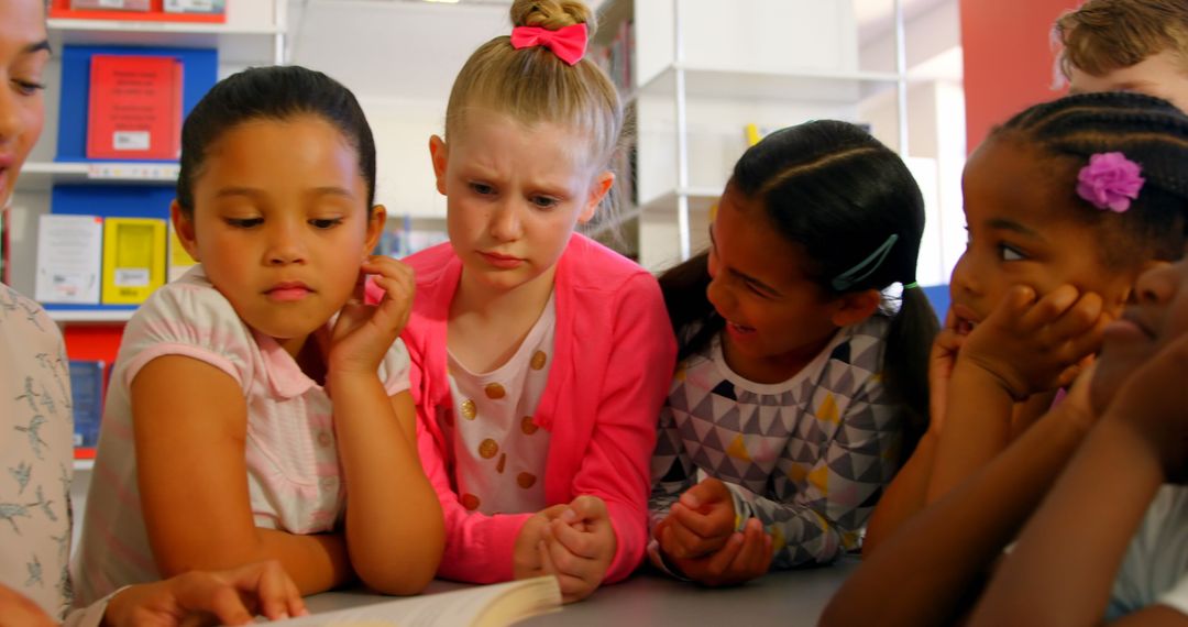 Engaged Schoolchildren Learning with Teacher in Library