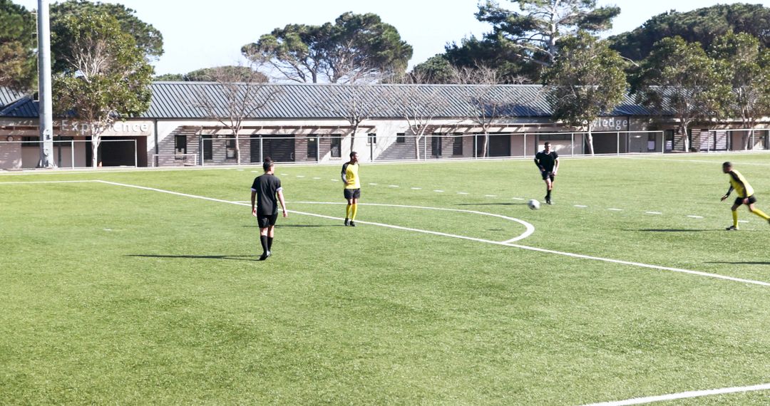 Soccer Players Practicing Teamwork on Sunny Outdoor Field