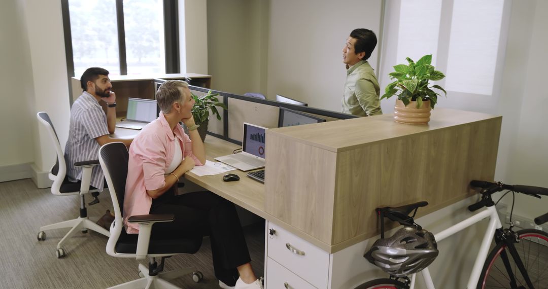 Diverse Coworkers Collaborating in Open Modern Office