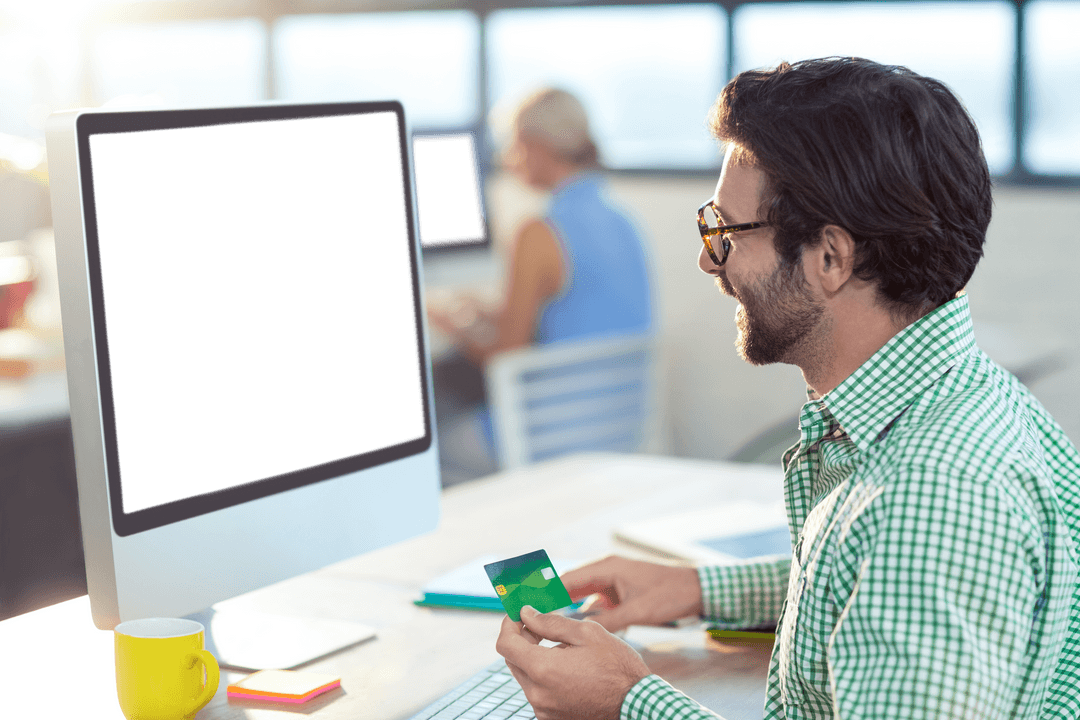 Graphic Designer Holding Credit Card with Transparent Computer Screen