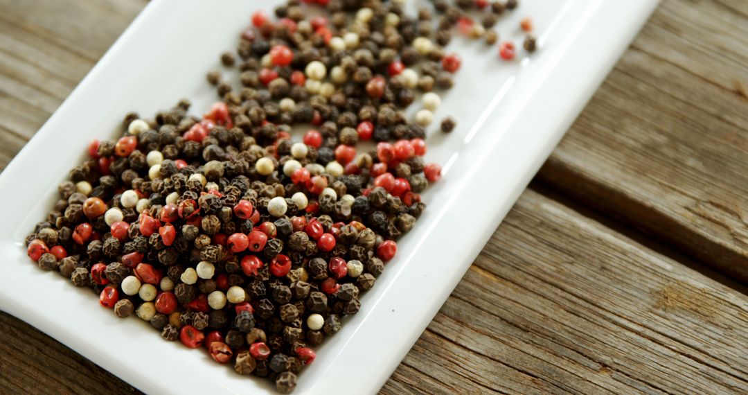 Assorted Peppercorns on White Rectangular Dish on Rustic Wood - Free Images, Stock Photos and Pictures on Pikwizard.com