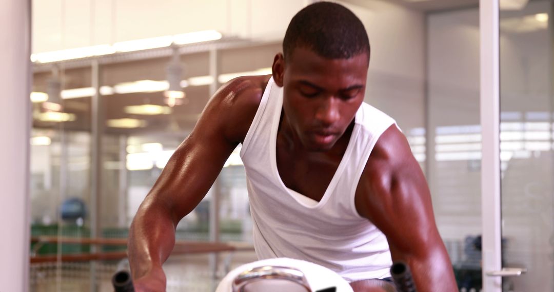 Fit Young Man Exercising on Stationary Bike at Gym - Free Images, Stock Photos and Pictures on Pikwizard.com