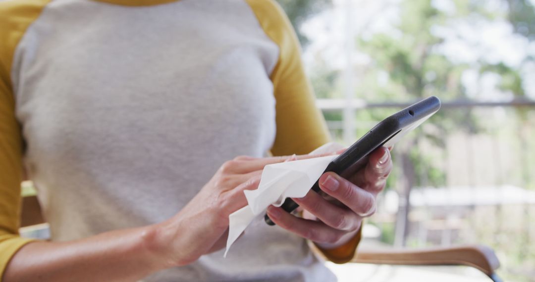 Person Cleaning Smartphone Screen with Wipe Close-up - Free Images, Stock Photos and Pictures on Pikwizard.com