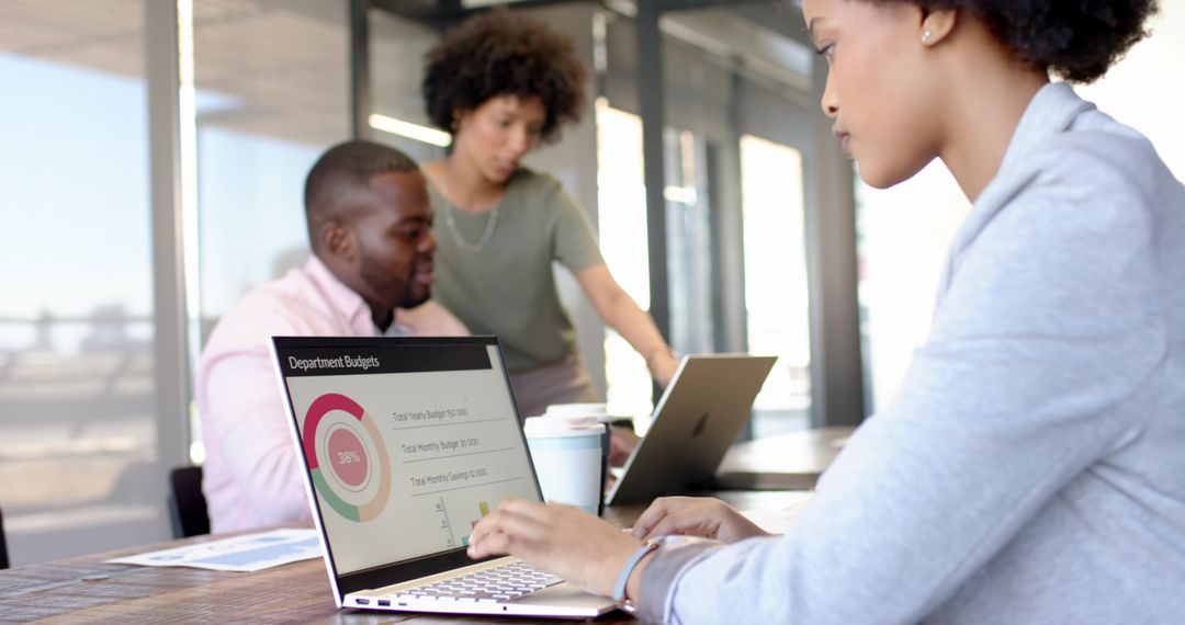 Diverse Team Analyzing Budget Chart in Modern Office Collaboration
