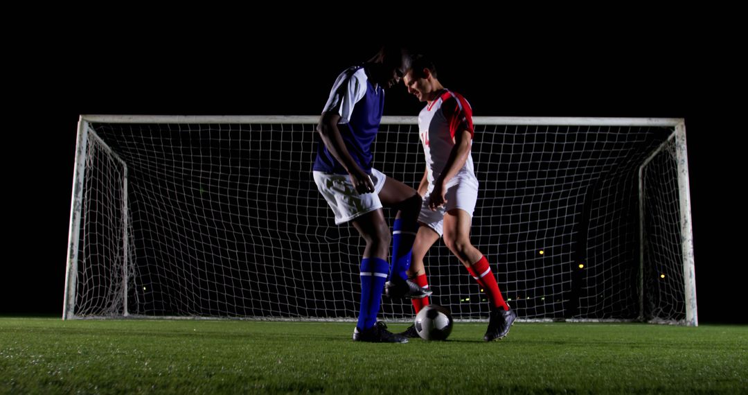 Soccer Players Competing for Ball on Dark Field - Free Images, Stock Photos and Pictures on Pikwizard.com