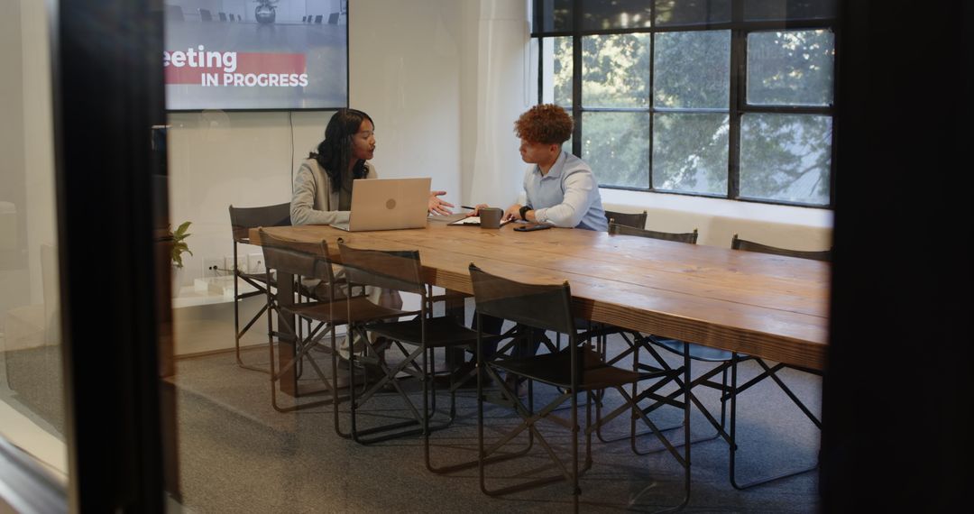 Diverse Team Collaborating on Project in Modern Conference Room