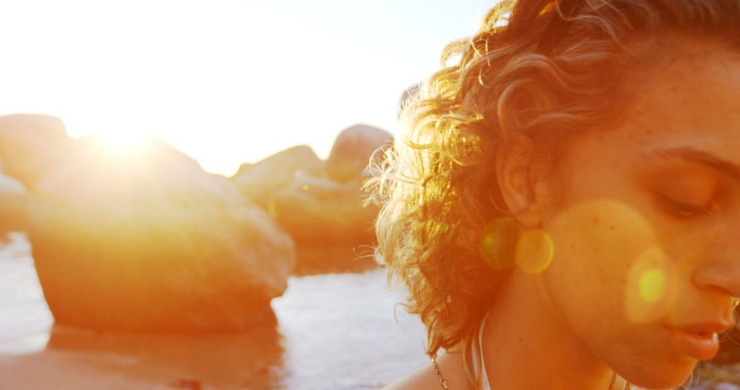 Woman Standing on Beach with Sunlight Behind - Free Images, Stock Photos and Pictures on Pikwizard.com