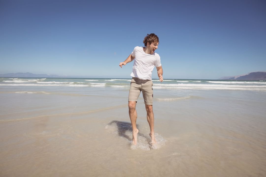 Young Man Enjoying Sunny Day at the Beach