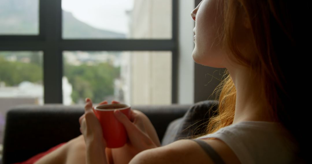 Woman Relaxing with Coffee Mug at Urban Window View - Free Images, Stock Photos and Pictures on Pikwizard.com