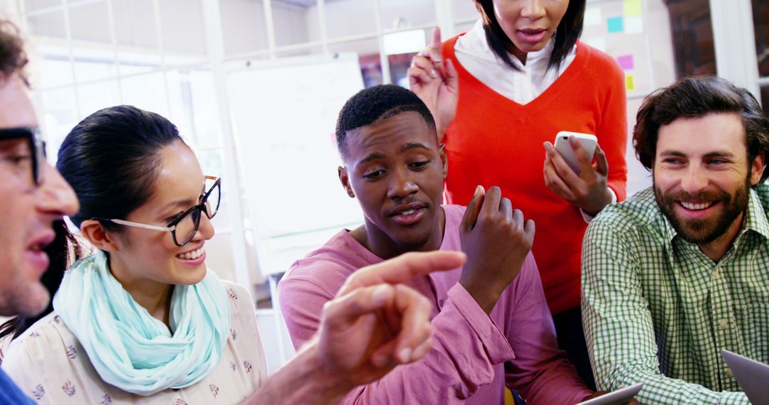 Team Collaborating on Digital Gadgets in Office Environment
