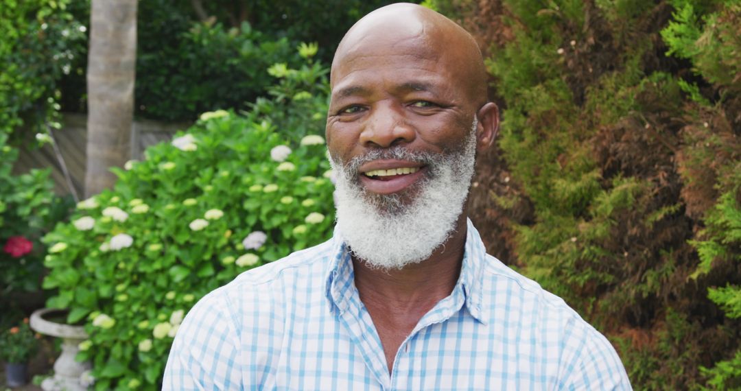 Smiling Senior African American Man in Lush Garden