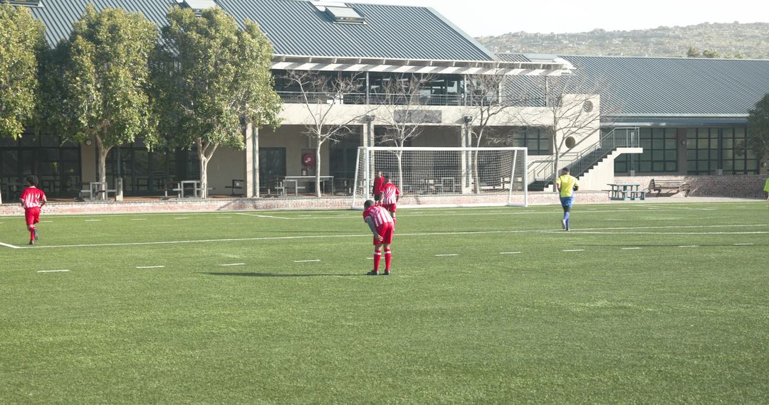 Youth Soccer Team Preparing for Match on School Field