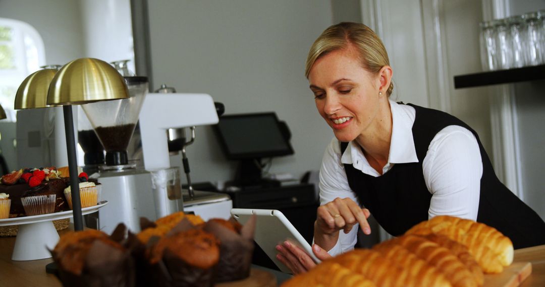 Female Baker Using Tablet Besides Freshly Baked Goods in Bakery - Free Images, Stock Photos and Pictures on Pikwizard.com